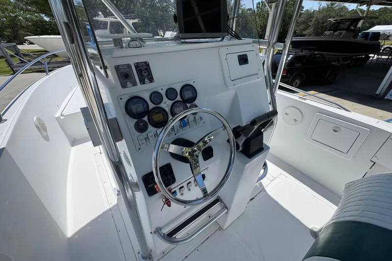 Slide: The Image of Center console of a 2000 Stamas 250 Tarpon boat with steering wheel and gauges. - 35