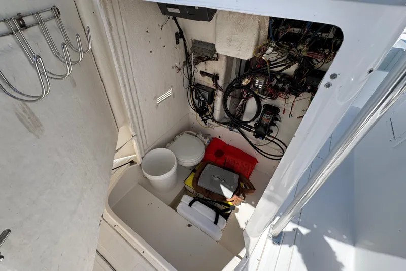 Slide: The Image of Storage compartment of a 2000 Stamas 250 Tarpon boat with wiring and equipment. - 30