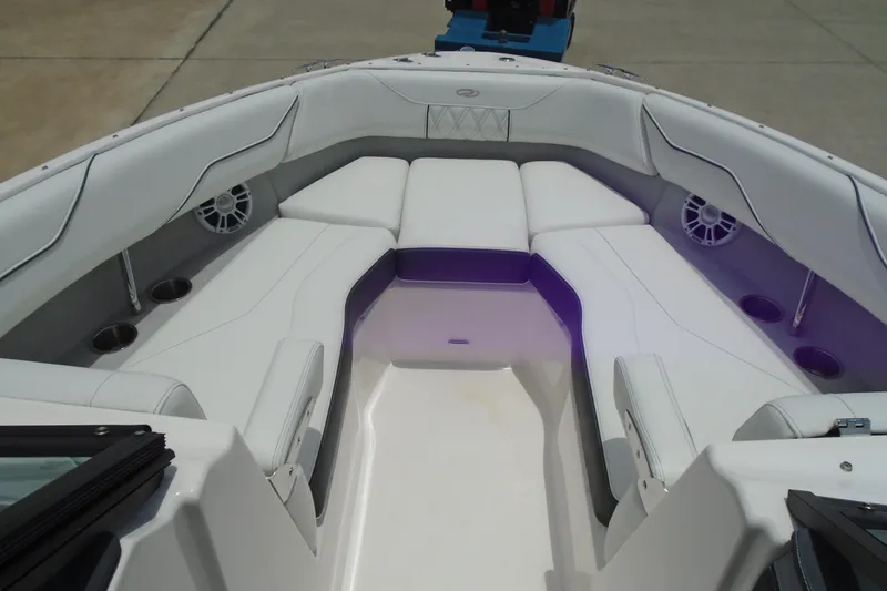 Slide: The Image of 2024 Regal LX4 boat interior with white seating and built-in speakers. - 6