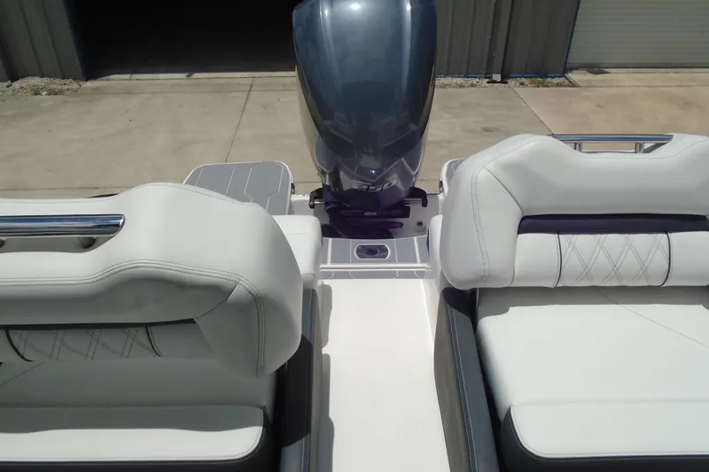 Slide: The Image of 2024 Regal LX4 boat interior with plush seating and powerful outboard motor. - 16