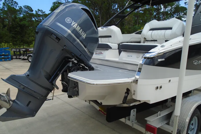 Slide: The Image of 2024 Regal LX4 boat with Yamaha outboard motor, featuring sleek design and comfortable seating. - 18