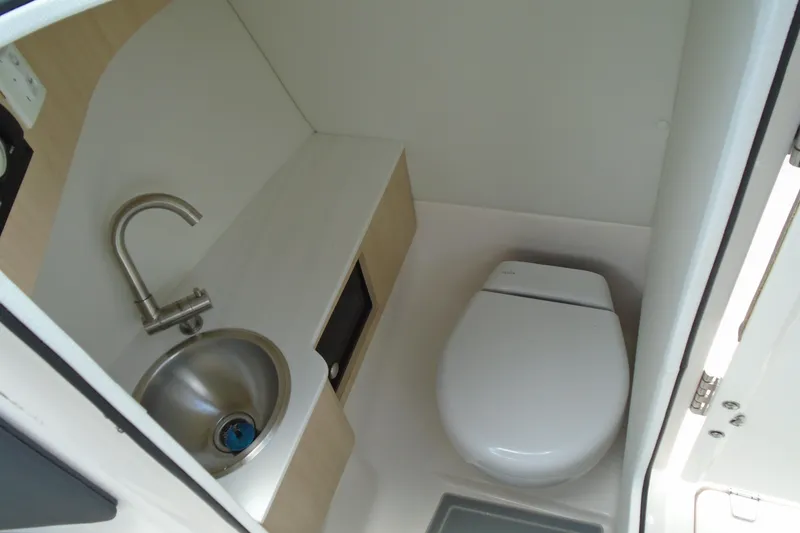 Slide: The Image of Compact bathroom in 2024 Regal LX4 boat with sink and toilet. - 5