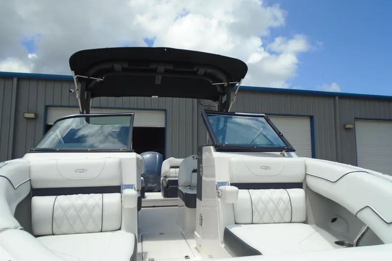 Slide: The Image of 2024 Regal LX4 boat interior with luxurious seating and sleek design under a blue sky. - 21