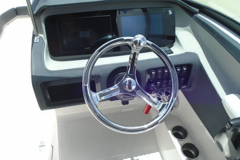 Slide: The Image of 2024 Regal LX4 boat dashboard with steering wheel and control panel. - 11
