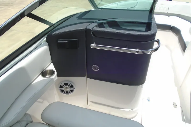 Slide: The Image of 2024 Regal LX4 boat interior with sleek seating, cup holder, and speaker system. - 12