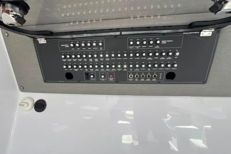 Slide: The Image of Control panel of 2023 Axopar Brabus 37 Sun-Top boat, featuring switches and indicators. - 9
