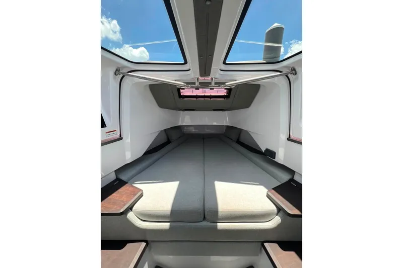 Slide: The Image of Interior cabin of 2023 Axopar Brabus 37 Sun-Top boat, featuring sleek design and skylight. - 18