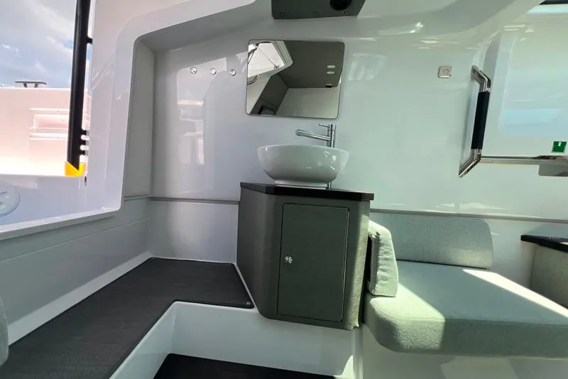 Slide: The Image of Interior of 2023 Axopar Brabus 37 Sun-Top, featuring modern sink and seating area. - 23