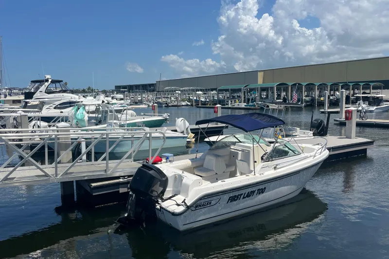 Slide: The Image of 2003 Boston Whaler 210 Ventura docked at marina under blue sky. - 6