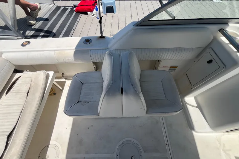 Slide: The Image of 2003 Boston Whaler 210 Ventura boat interior with white seating and deck details. - 17