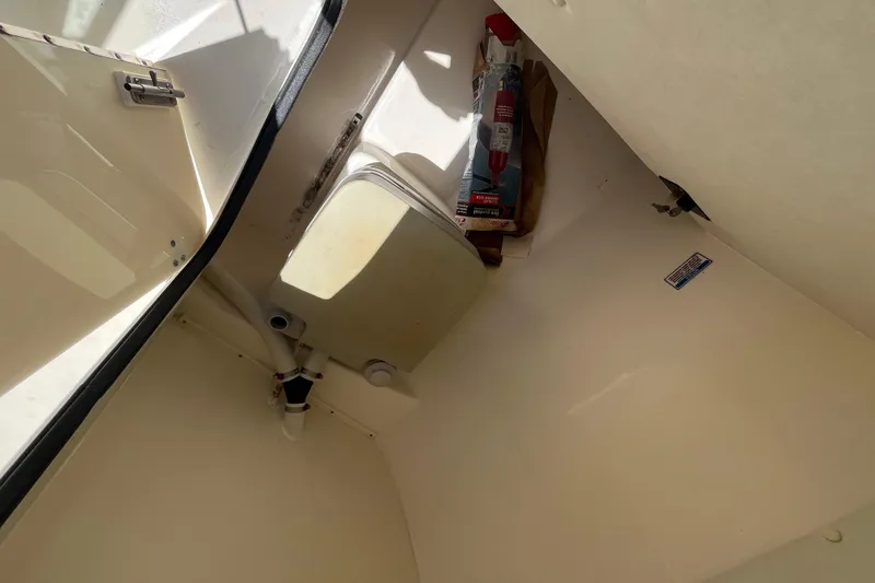 Slide: The Image of Interior of a 2003 Boston Whaler 210 Ventura boat, showing storage compartment. - 16