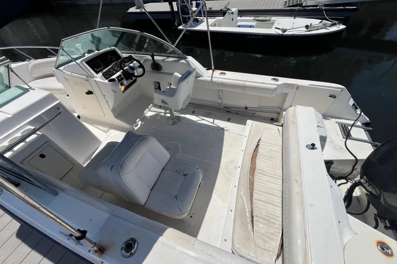 Slide: The Image of 2003 Boston Whaler 210 Ventura boat interior with seating and control panel. - 13