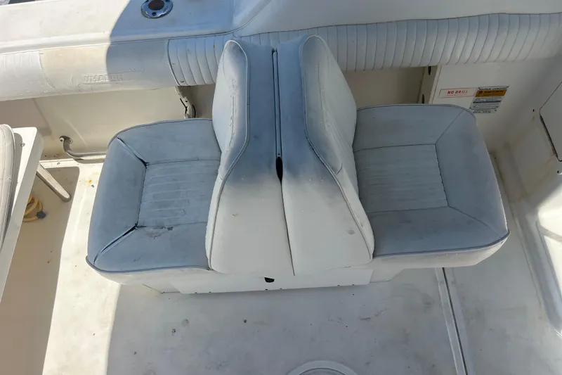 Slide: The Image of 2003 Boston Whaler 210 Ventura boat seats, showing wear and sun exposure. - 15