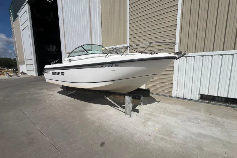 Slide: The Image of 2003 Boston Whaler 210 Ventura boat on trailer outside storage facility. - 2