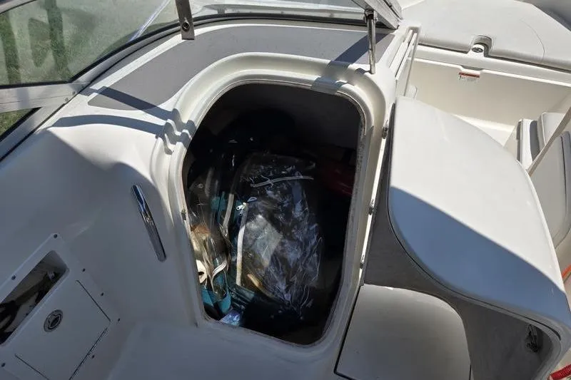 Slide: The Image of Storage compartment of a 2004 Aquasport 215 Osprey Sport boat, partially open. - 17