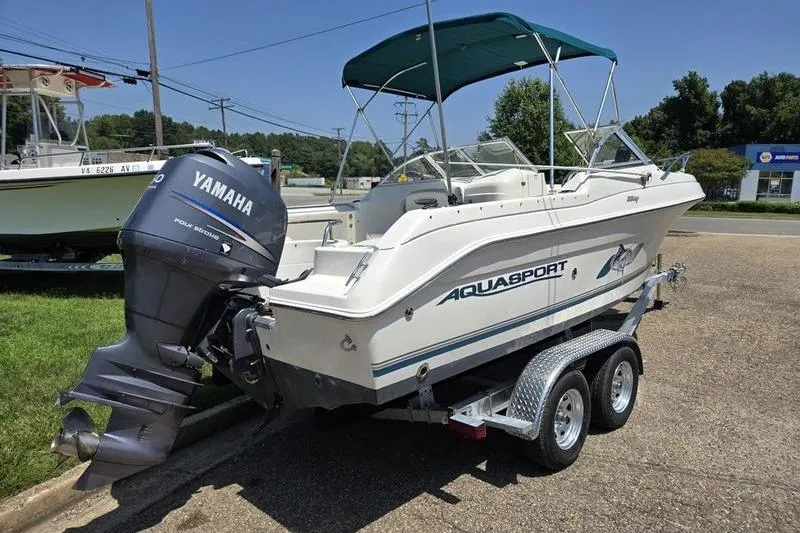 Slide: The Image of 2004 Aquasport 215 Osprey Sport boat with Yamaha outboard motor on trailer. - 9