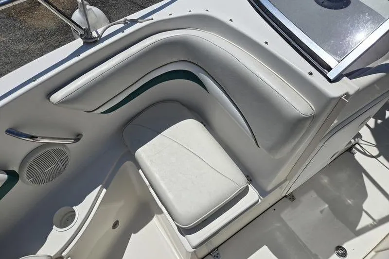 Slide: The Image of 2004 Aquasport 215 Osprey Sport boat interior with white seating and speaker. - 3