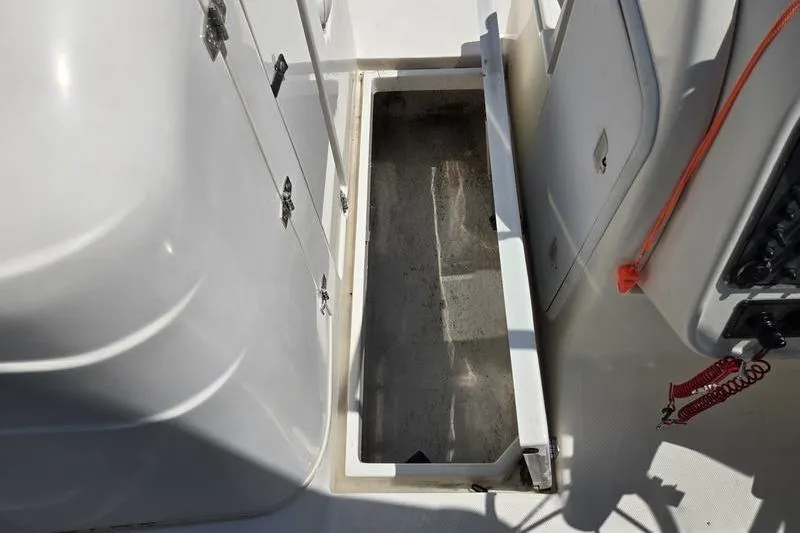 Slide: The Image of Open storage compartment on 2004 Aquasport 215 Osprey Sport boat deck. - 4