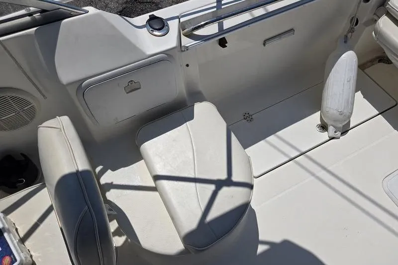 Slide: The Image of 2004 Aquasport 215 Osprey Sport boat interior with seating and storage compartments. - 15