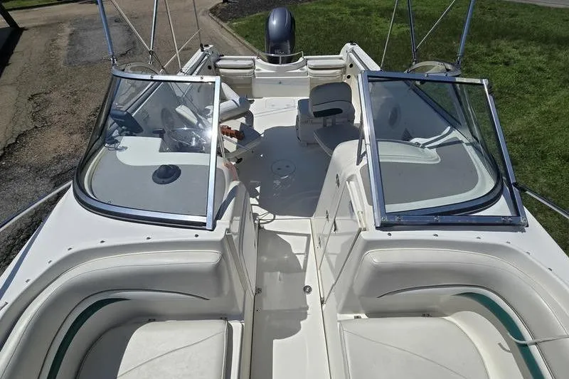 Slide: The Image of 2004 Aquasport 215 Osprey Sport boat interior with seating and windshield. - 1
