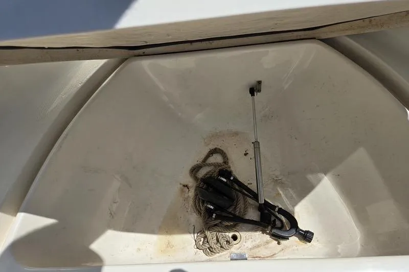 Slide: The Image of Storage compartment of 2004 Aquasport 215 Osprey Sport with rope and equipment. - 8