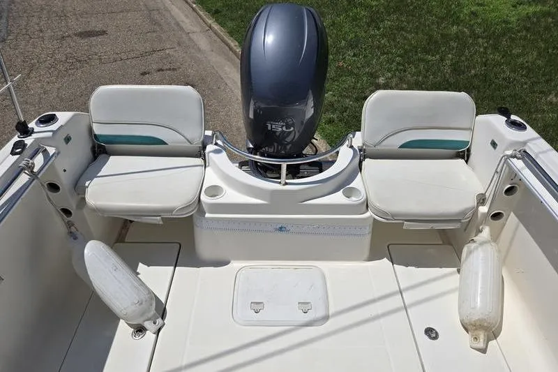 Slide: The Image of 2004 Aquasport 215 Osprey Sport boat with dual seats and outboard motor. - 6