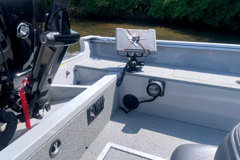 Slide: The Image of 2025 Smoker Craft Freedom 160 TL boat interior with mounted equipment and motor detail. - 10