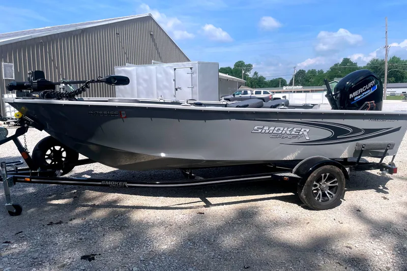 Slide: The Image of 2025 Smoker Craft Freedom 160 TL boat on trailer, featuring Mercury engine, parked outdoors. - 4