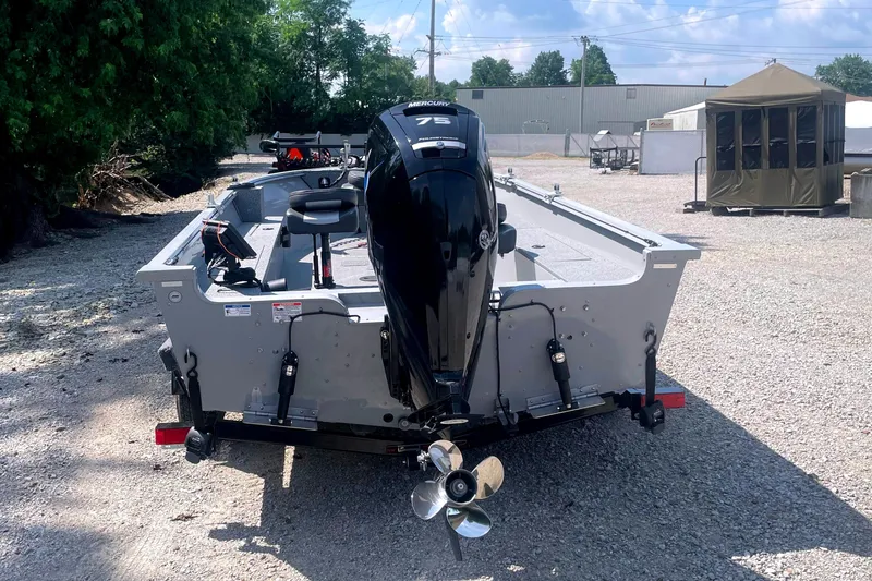 Slide: The Image of 2025 Smoker Craft Freedom 160 TL boat with Mercury 75 engine, parked on gravel. - 6