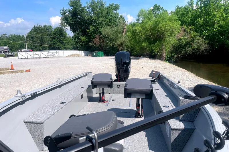 Slide: The Image of 2025 Smoker Craft Freedom 160 TL boat at a gravel launch site, surrounded by trees. - 8