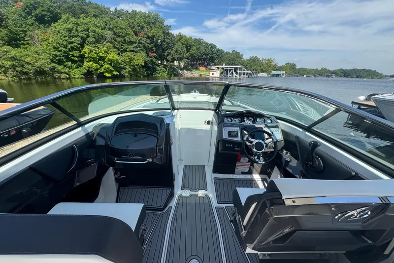 Slide: The Image of 2020 Monterey 298SS Super Sport boat interior with sleek dashboard and lake view. - 3