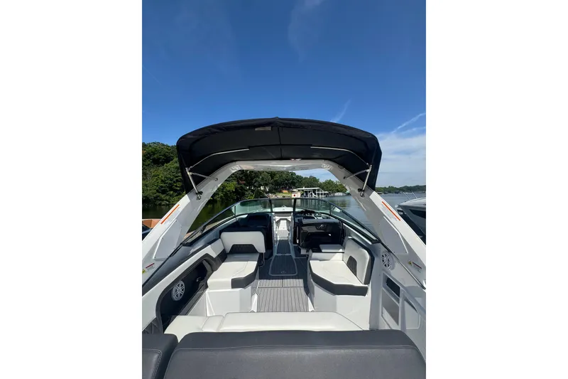Slide: The Image of 2020 Monterey 298SS Super Sport boat interior with seating, under clear blue sky. - 2