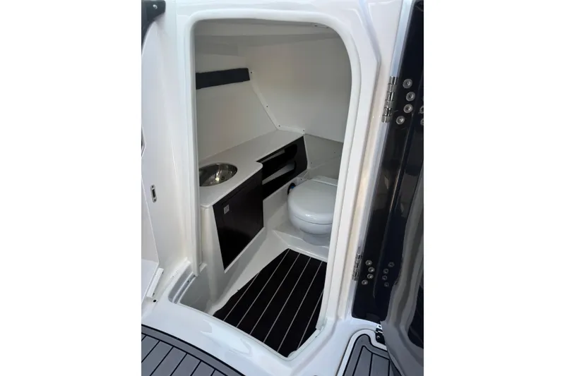 Slide: The Image of 2020 Monterey 298SS Super Sport boat interior with compact bathroom and modern fixtures. - 10