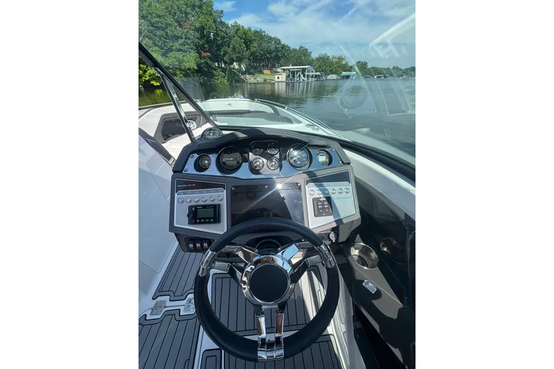 Slide: The Image of Cockpit view of 2020 Monterey 298SS Super Sport boat with modern dashboard and steering wheel. - 5