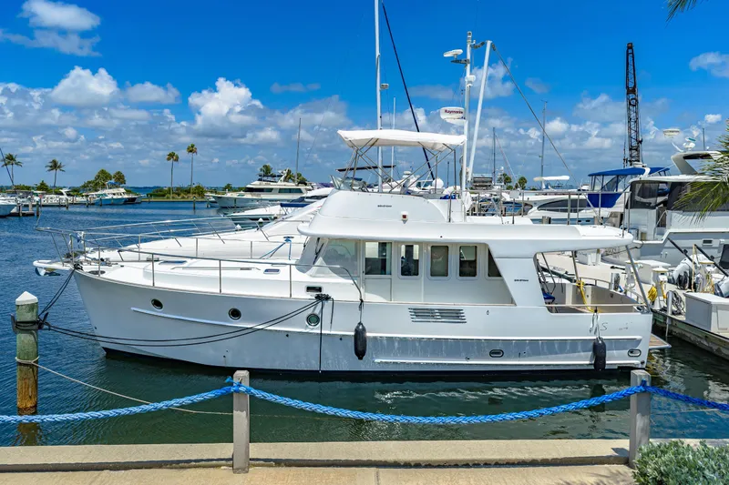 Slide: The Image of 2006 Beneteau Swift Trawler 42 docked at marina under clear blue sky. - 3