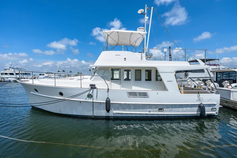 Slide: The Image of 2006 Beneteau Swift Trawler 42 docked at marina under clear blue sky. - 27