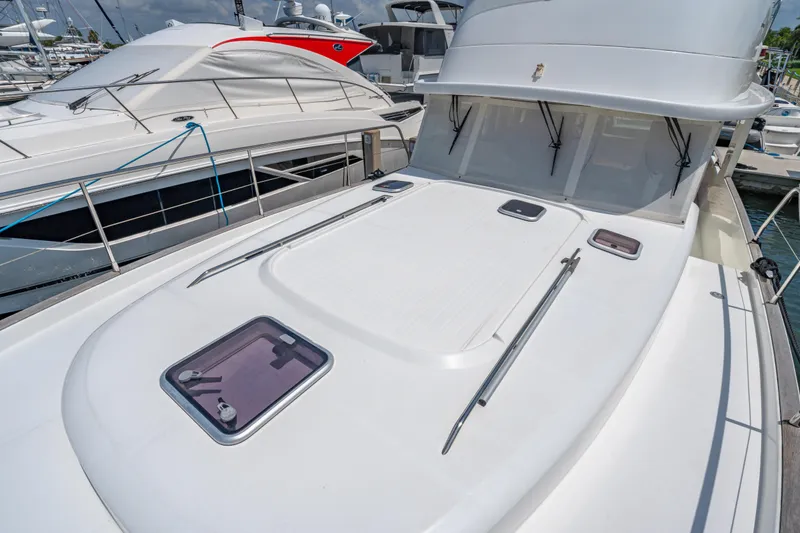 Slide: The Image of 2006 Beneteau Swift Trawler 42 docked, showcasing sleek deck design and modern features. - 45