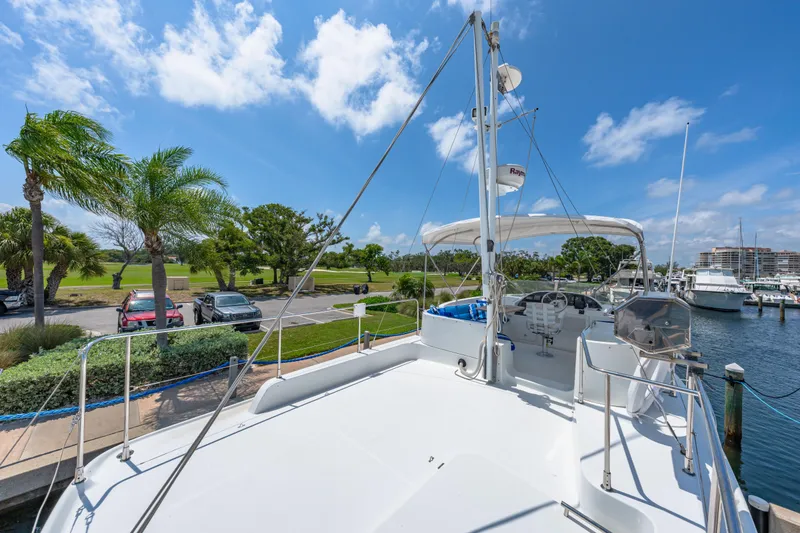 Slide: The Image of 2006 Beneteau Swift Trawler 42 docked, showcasing spacious deck and marina view. - 51