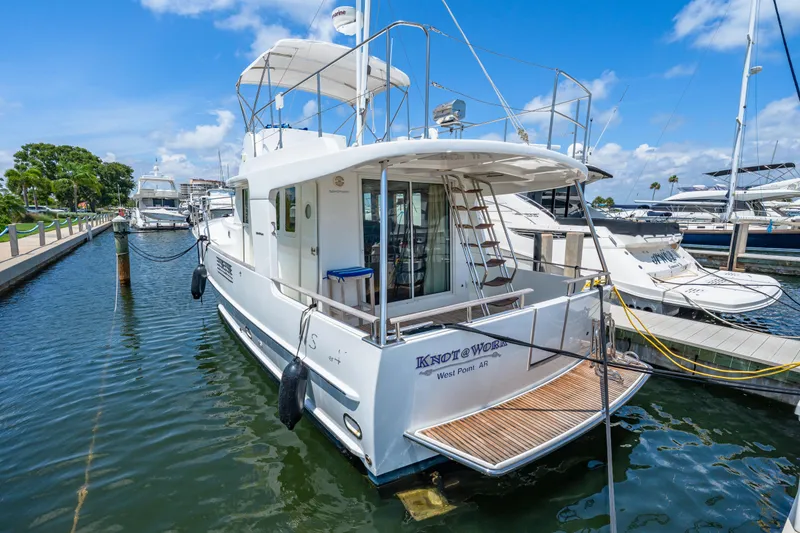 Slide: The Image of 2006 Beneteau Swift Trawler 42 docked at marina, featuring spacious deck and elegant design. - 29