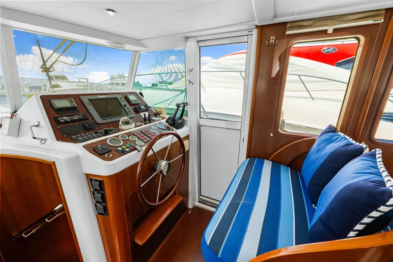 Slide: The Image of Interior helm of 2006 Beneteau Swift Trawler 42 with navigation controls and seating. - 70