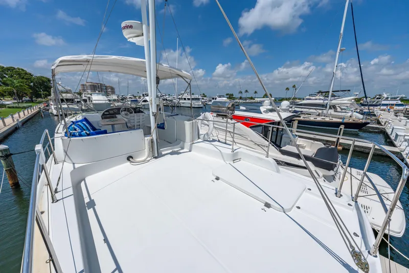 Slide: The Image of 2006 Beneteau Swift Trawler 42 docked at marina under clear blue sky. - 50