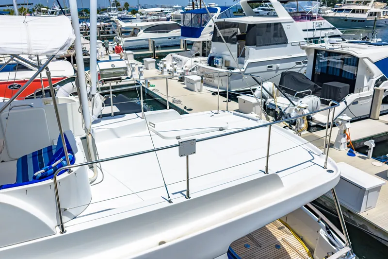 Slide: The Image of 2006 Beneteau Swift Trawler 42 docked at a marina, surrounded by other boats. - 24