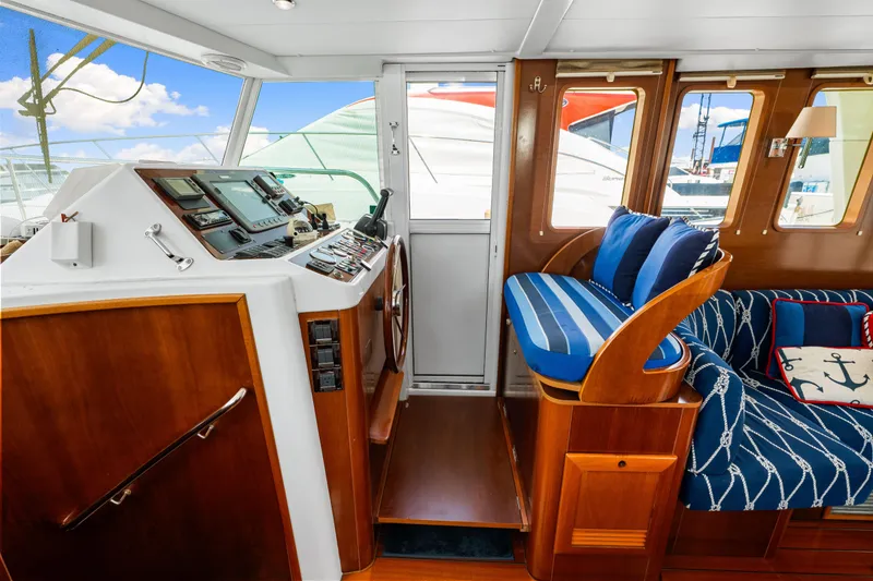 Slide: The Image of Interior of 2006 Beneteau Swift Trawler 42 with nautical-themed seating and helm station. - 69
