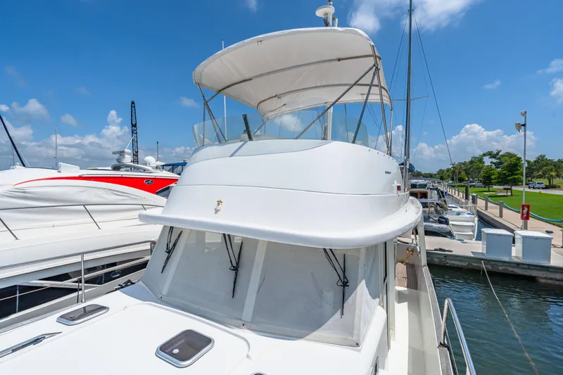 Slide: The Image of 2006 Beneteau Swift Trawler 42 docked at marina under clear blue sky. - 46