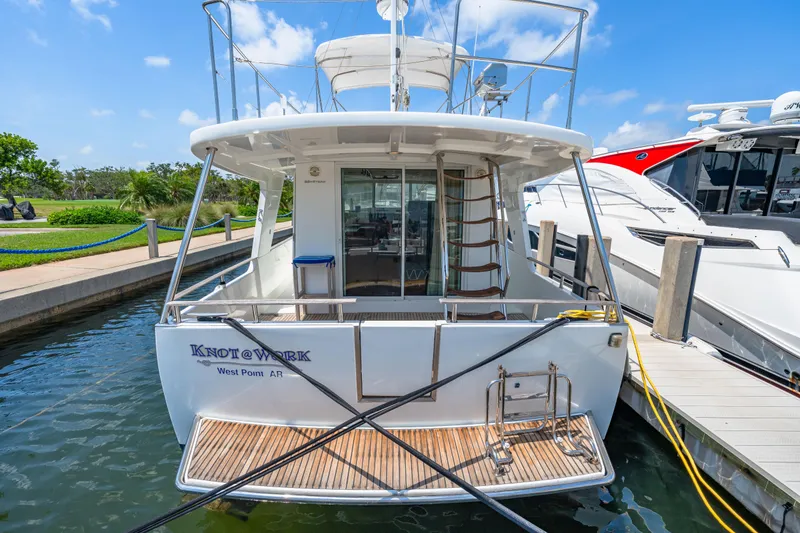 Slide: The Image of 2006 Beneteau Swift Trawler 42 docked, rear view with ladder and deck. - 30