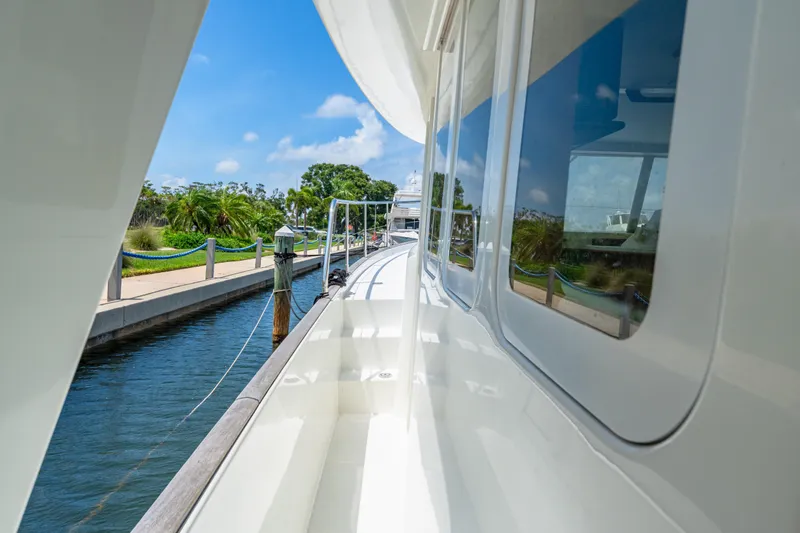 Slide: The Image of Side view of a 2006 Beneteau Swift Trawler 42 docked by a scenic canal. - 40