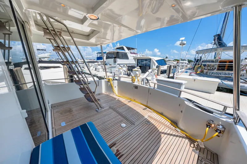 Slide: The Image of 2006 Beneteau Swift Trawler 42 docked, featuring spacious deck and marina view. - 39