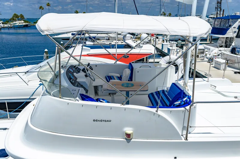 Slide: The Image of 2006 Beneteau Swift Trawler 42 docked, featuring spacious deck and seating area. - 23