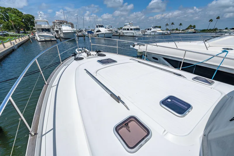 Slide: The Image of 2006 Beneteau Swift Trawler 42 docked in a marina under a clear blue sky. - 41