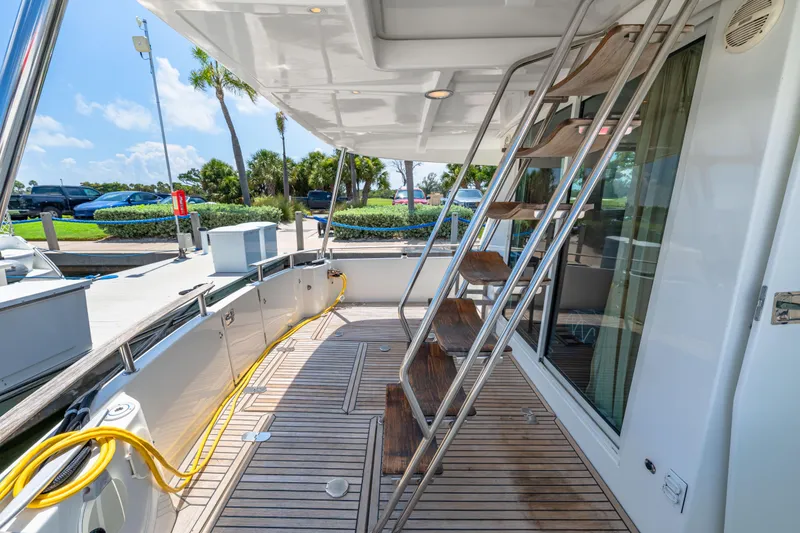 Slide: The Image of 2006 Beneteau Swift Trawler 42 deck with wooden flooring and metal stairs. - 34